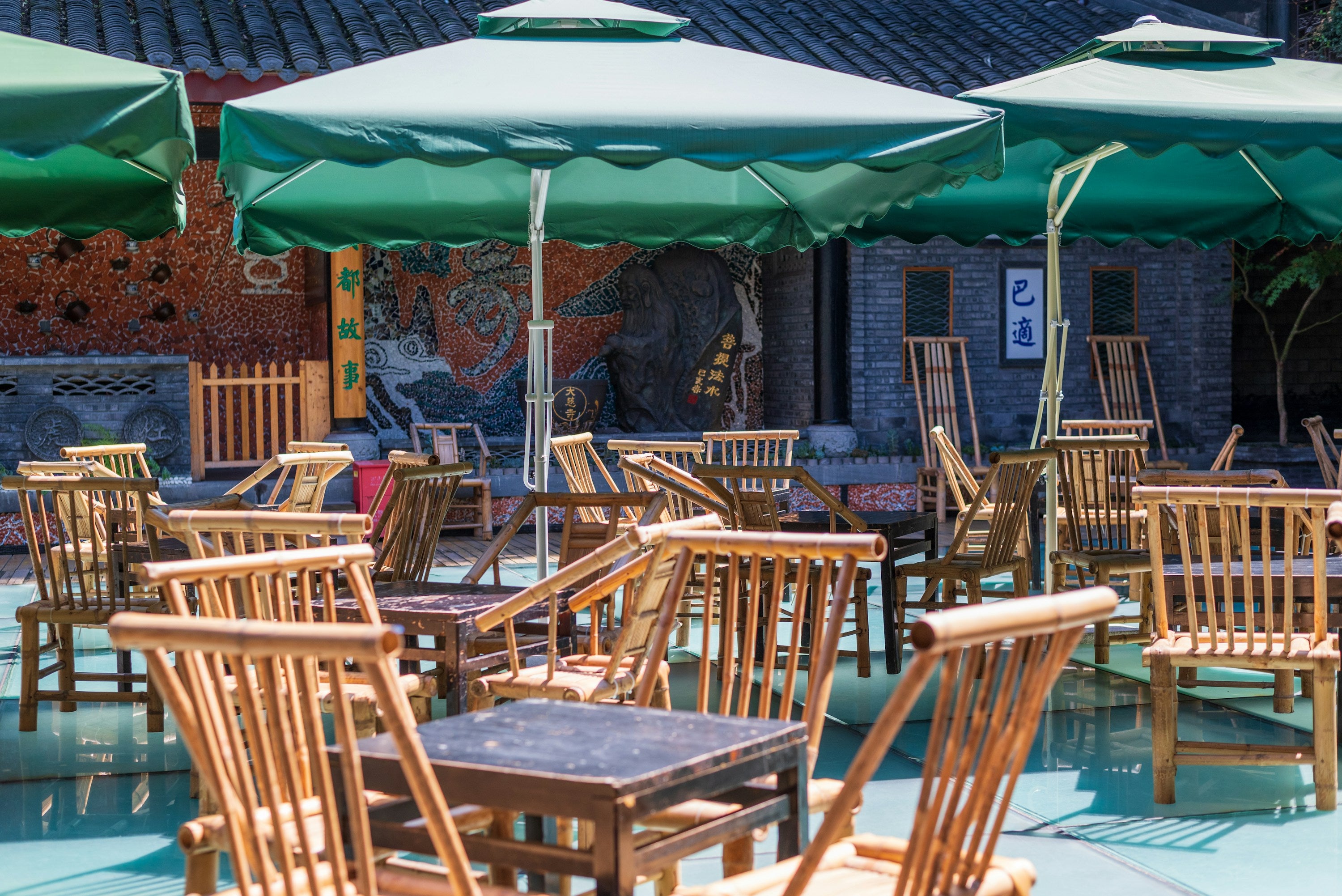 Bamboo chairs and shaded tables at a teahouse by Daci Temple in Chengdu.
