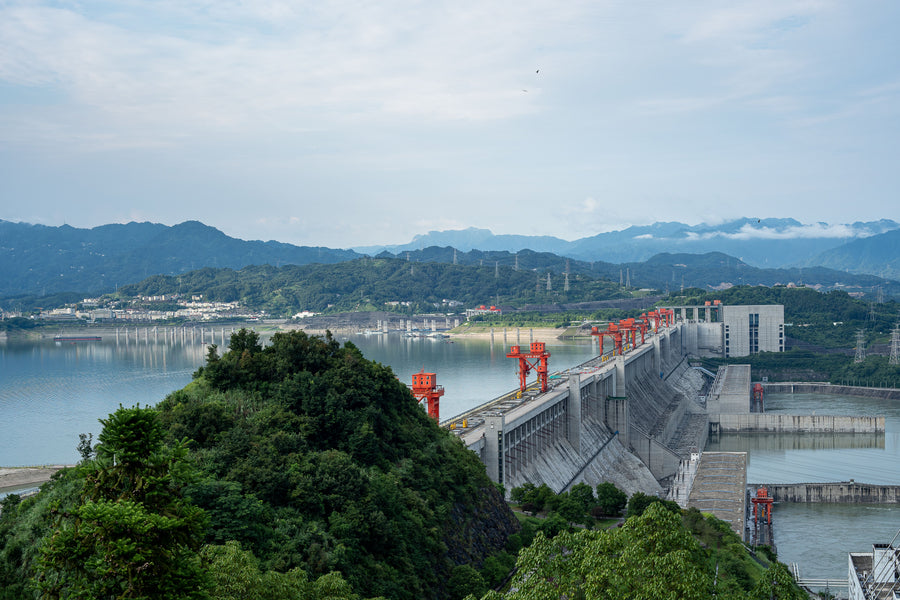 Three Gorges Dam and reservoir stretching across a mountainous Yangtze landscape.