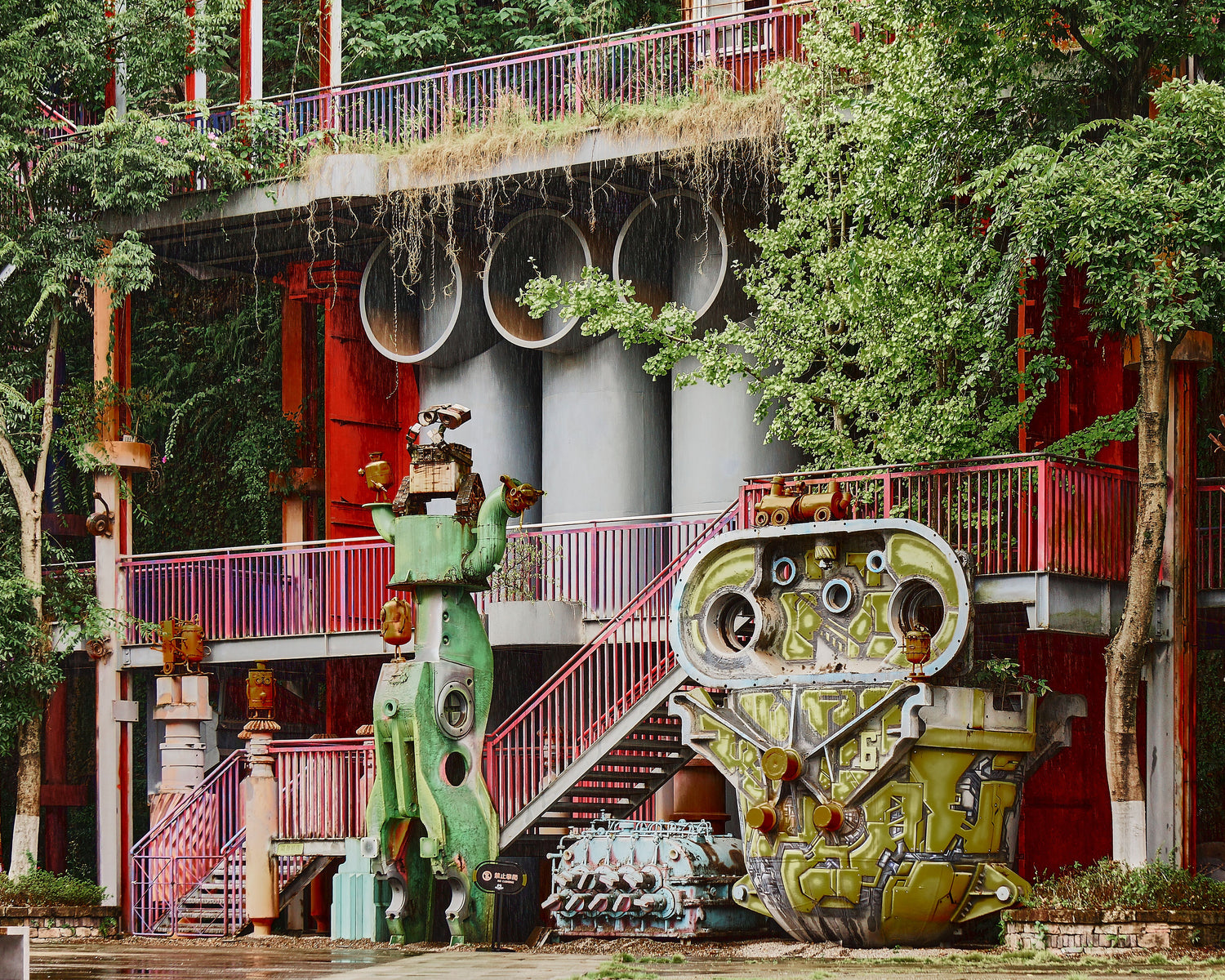 Machinery-based art installations among trees at a former steel plant in Chongqing.