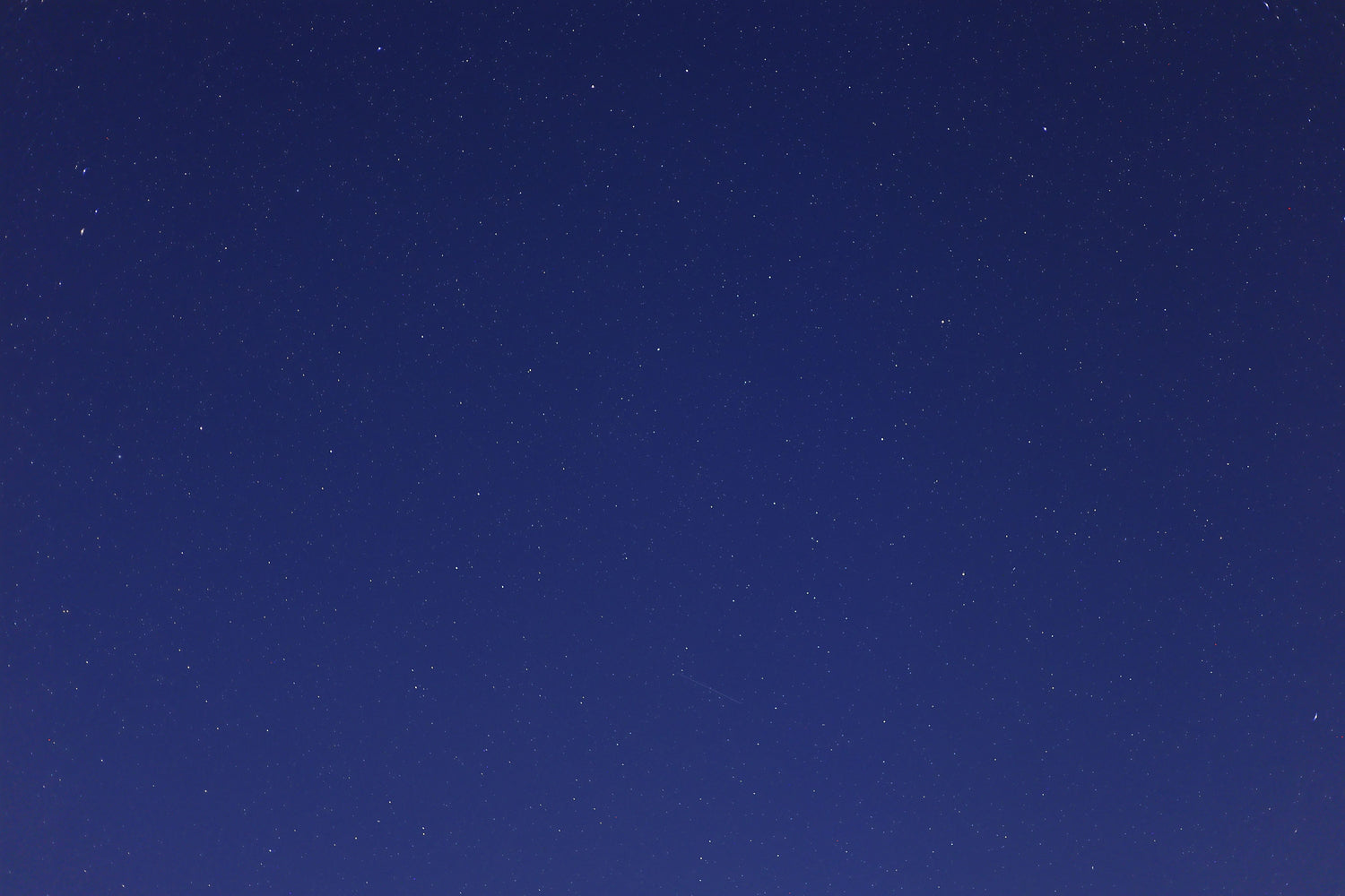 Stars scattered across a clear deep-blue night sky.