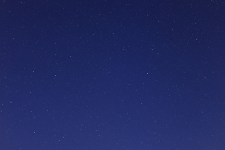 Stars scattered across a clear deep-blue night sky.