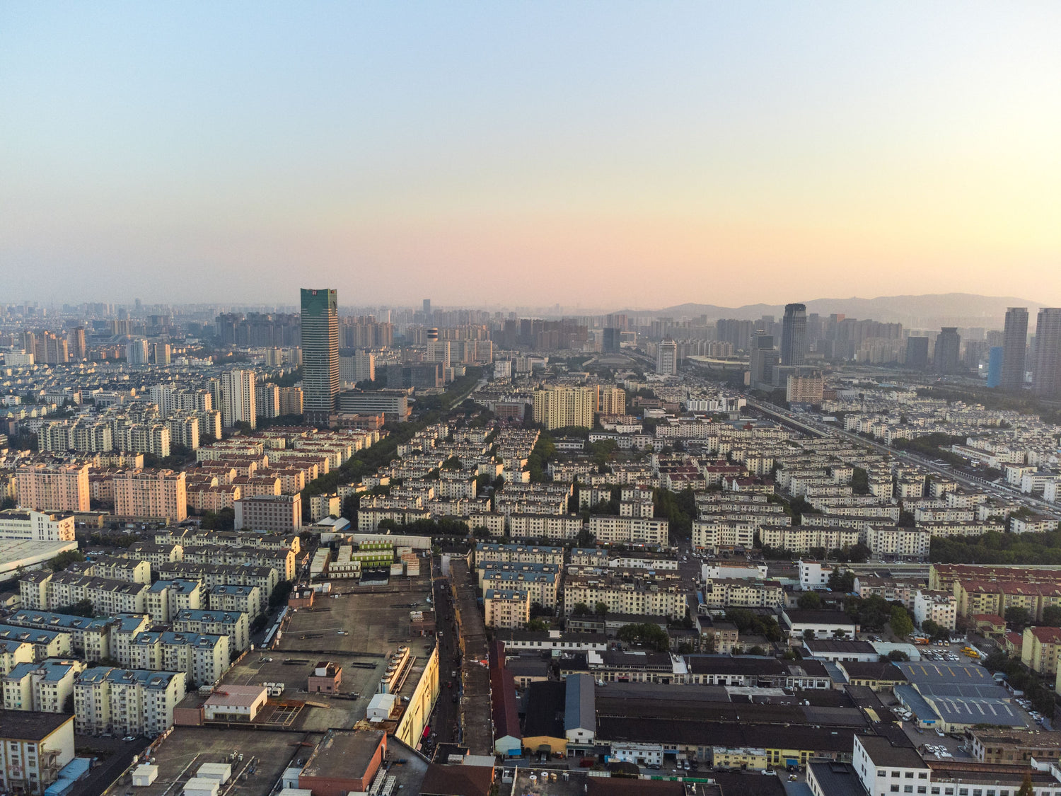 Aerial view of Suzhou's modern city skyline at dusk.
