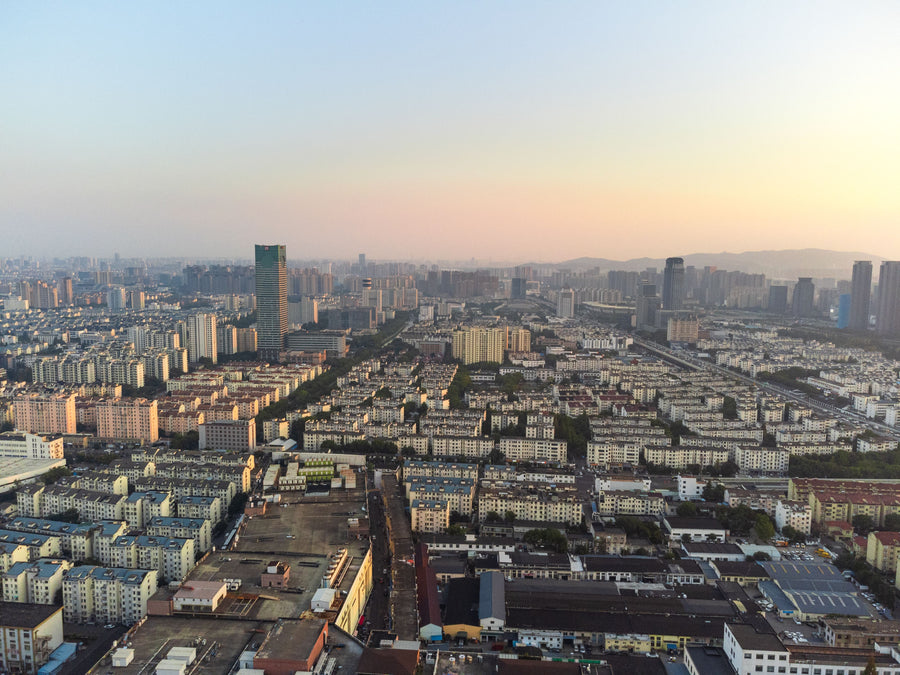 Aerial view of Suzhou's modern city skyline at dusk.
