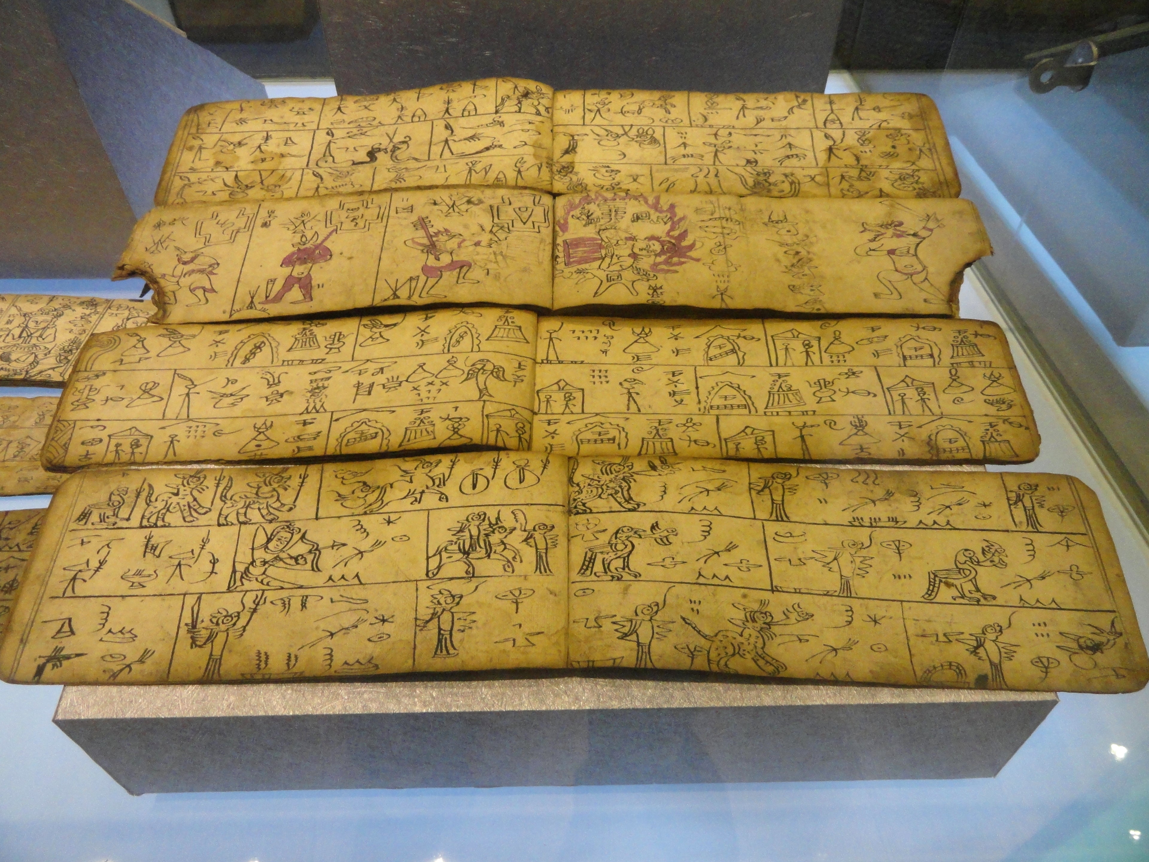 Naxi Dongba pictographic scripture displayed in a Yunnan museum.