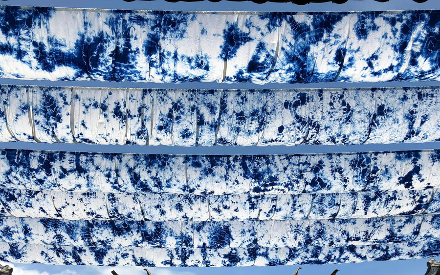 Indigo tie-dyed textiles hanging in Zhoucheng, Dali.