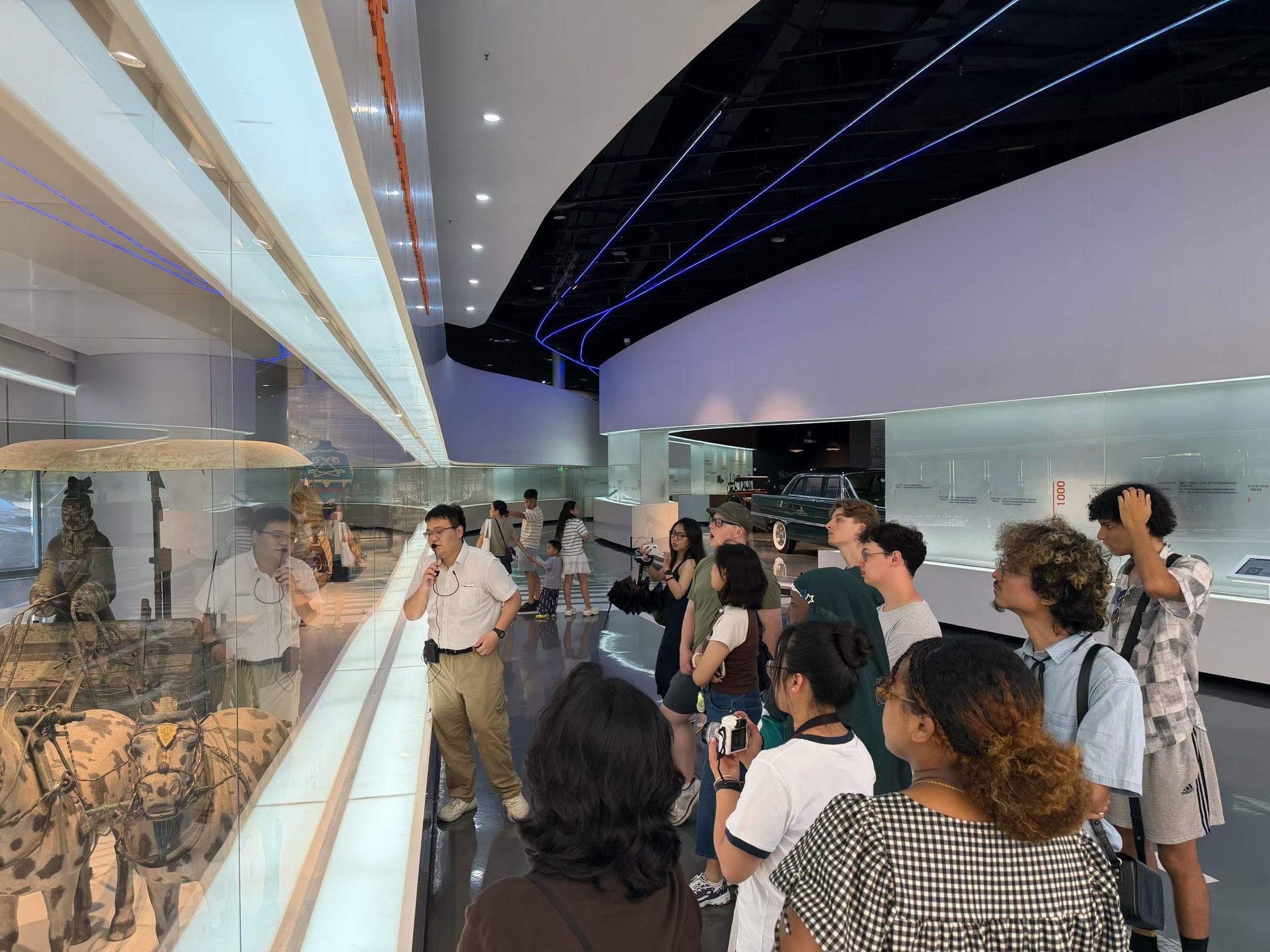 An international group listening to a guide during a hosted visit in China