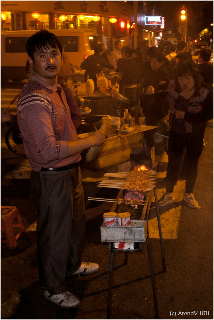 Street-food preparation on a side street off Nanjing Road in Shanghai at night